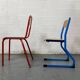 Set of 2 mismatched industrial school chairs