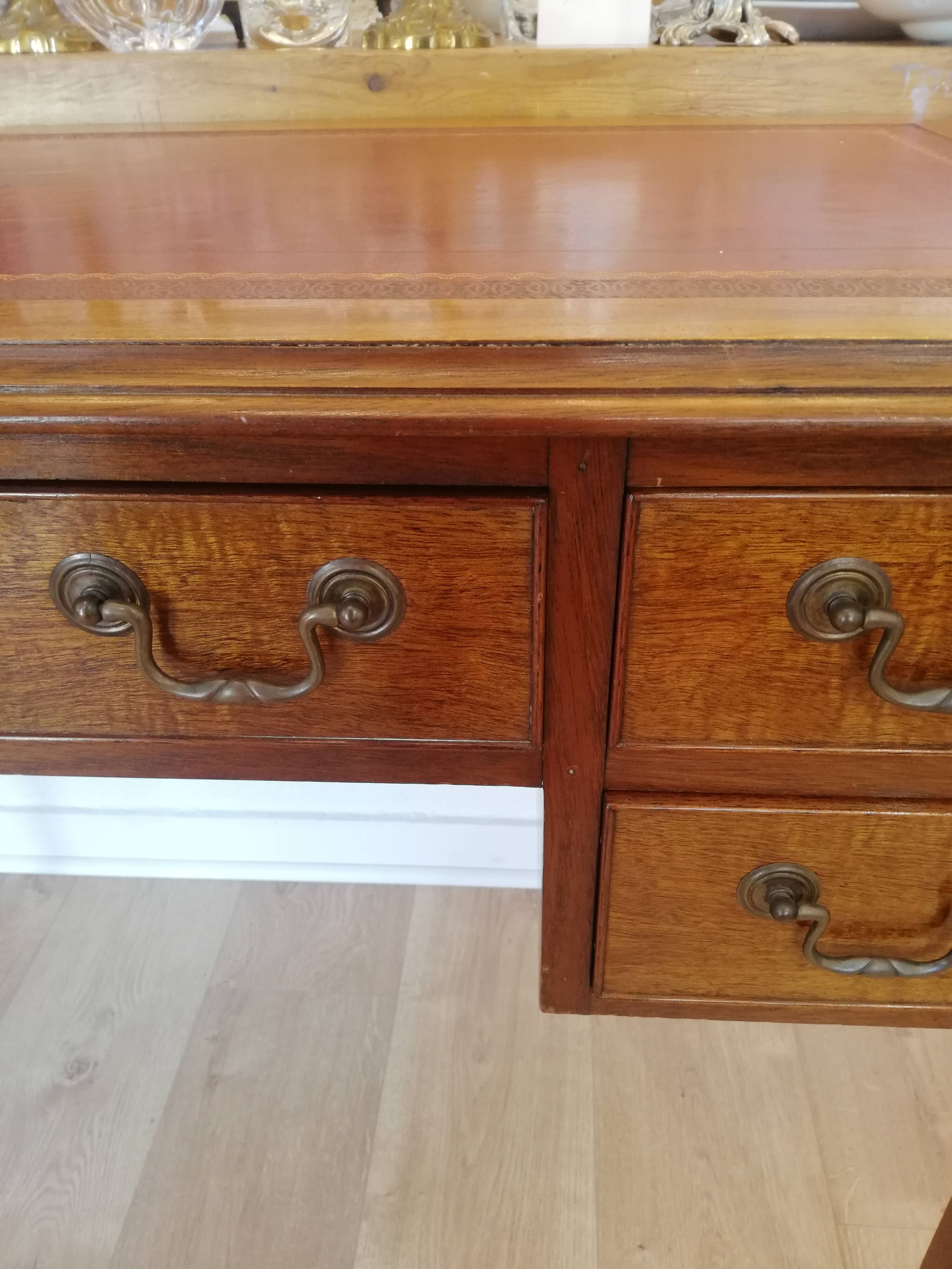 English wooden desk on top of leather