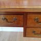 English wooden desk on top of leather