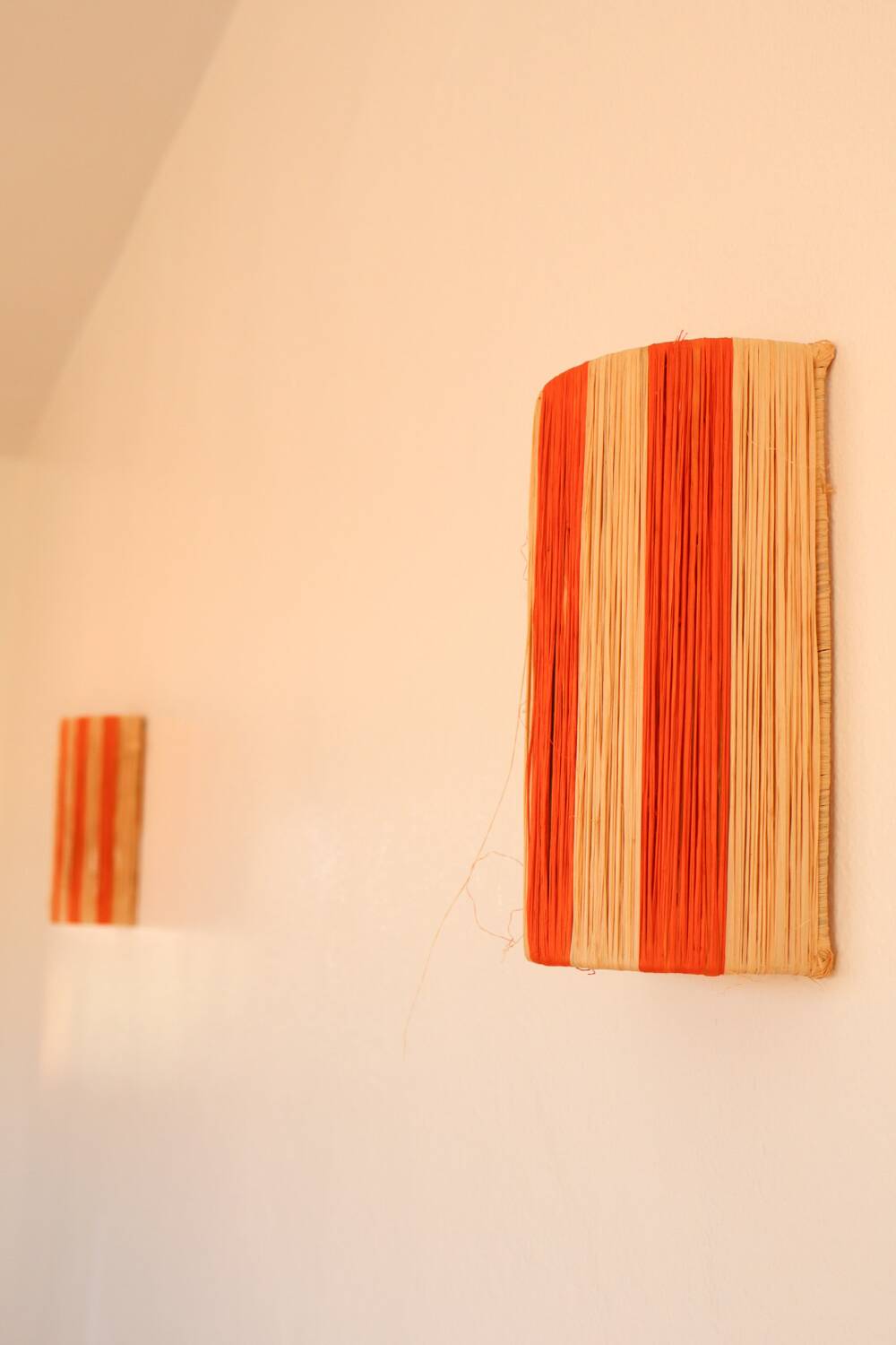 Orange and natural striped raffia wall light