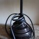Table lamp with a patinated base and vintage woven shade.