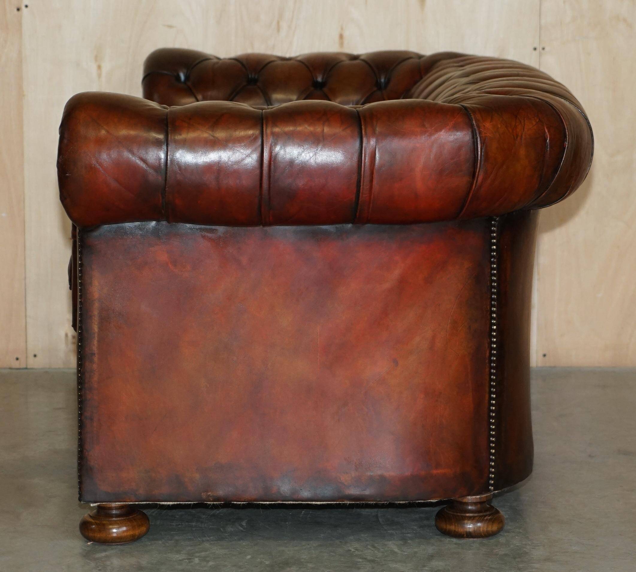 Pair of restored antique Chesterfield sofas in Boudreaux leather.