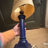 Corinthian column lamp base in blue with a lampshade of dried flowers.