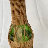 Green bottle with wicker decoration