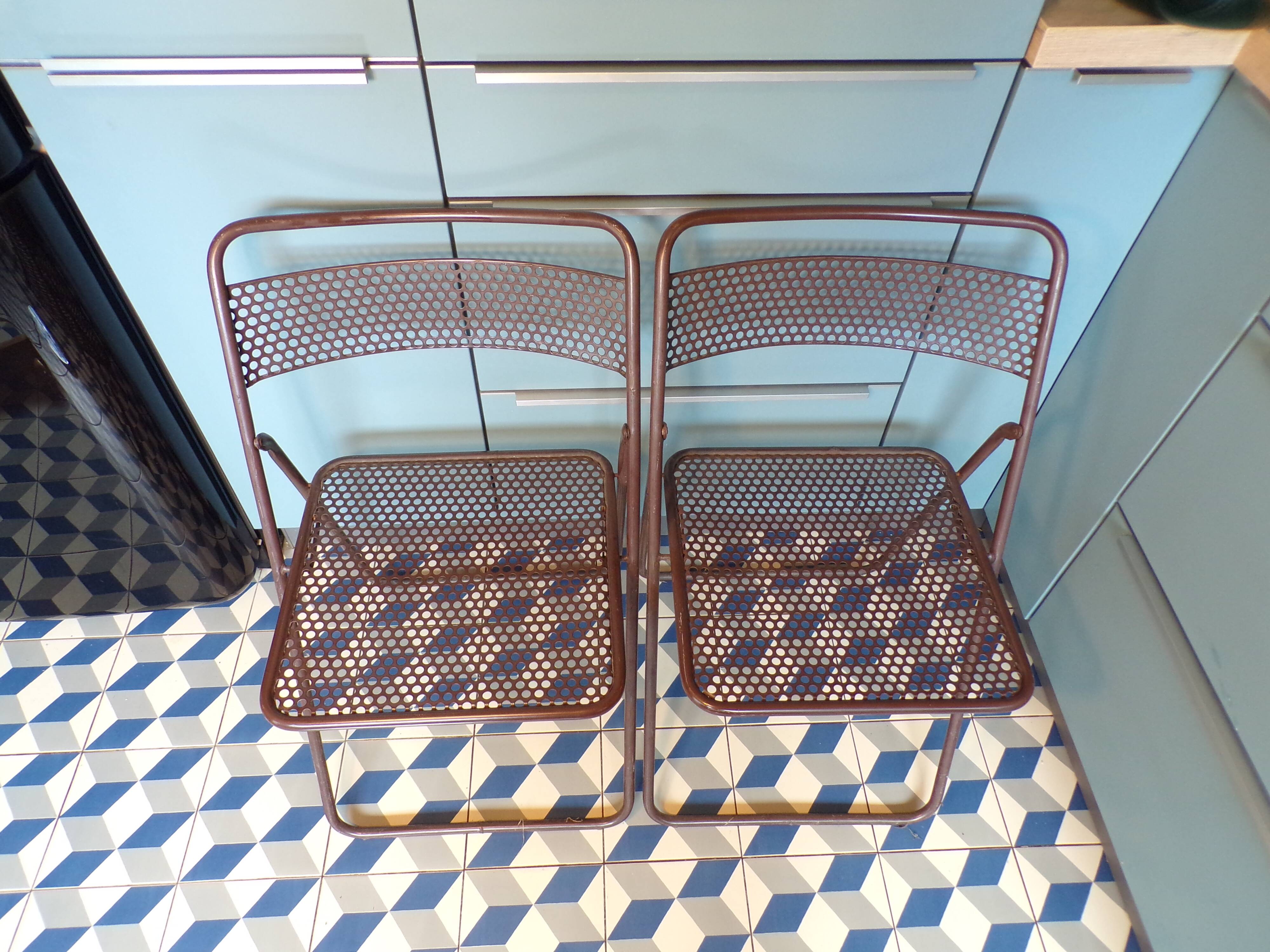 Pair of folding chairs in perforated sheet metal