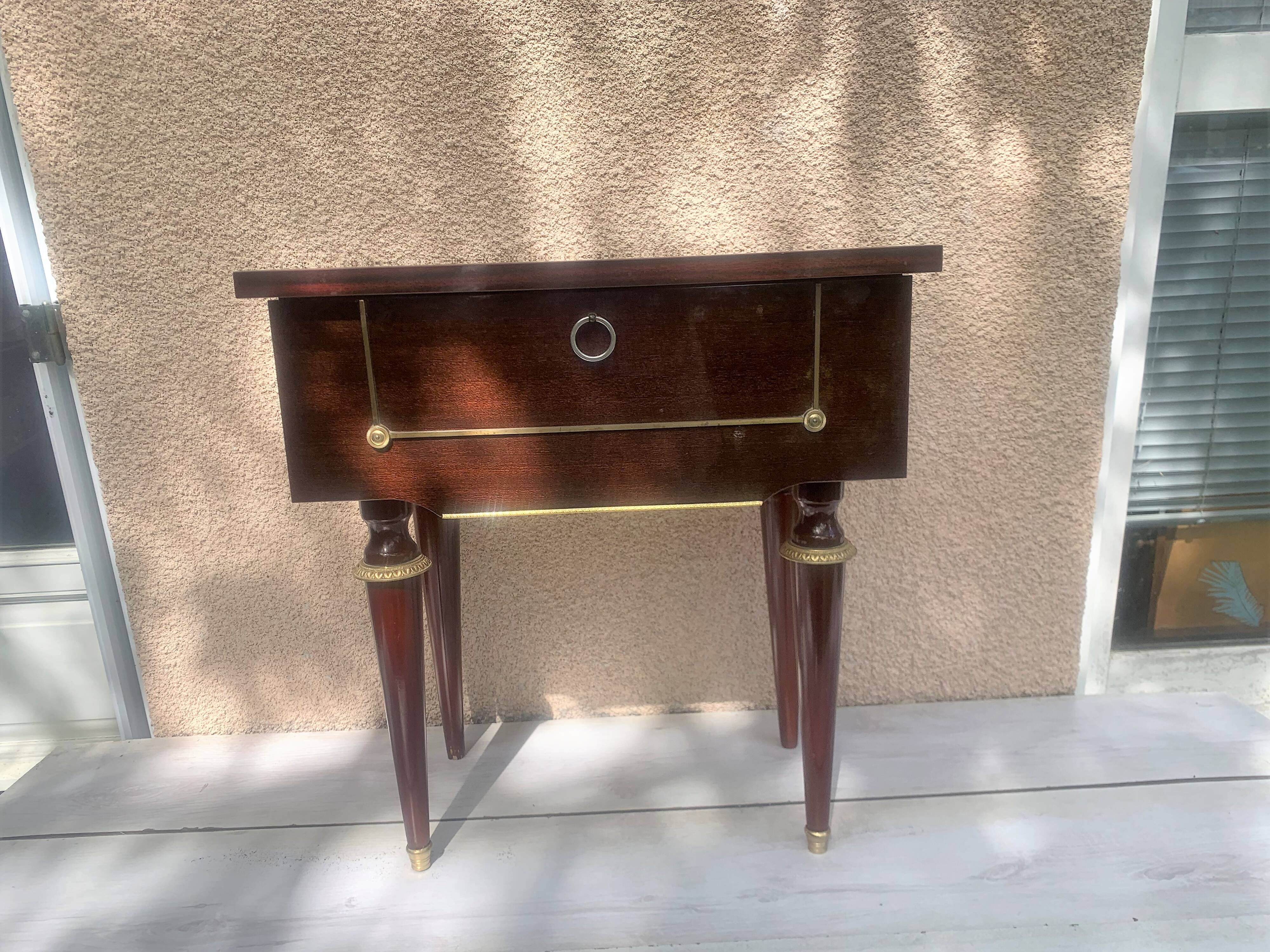 Nightstand with lovely mid-century style gold metal decor.