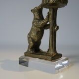 Brass sculpture, bear looking for honey in the tree