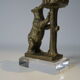Brass sculpture, bear looking for honey in the tree