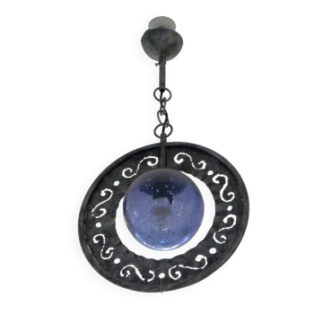 Patinated metal chandelier with cobalt blue blown glass in a rustic style.