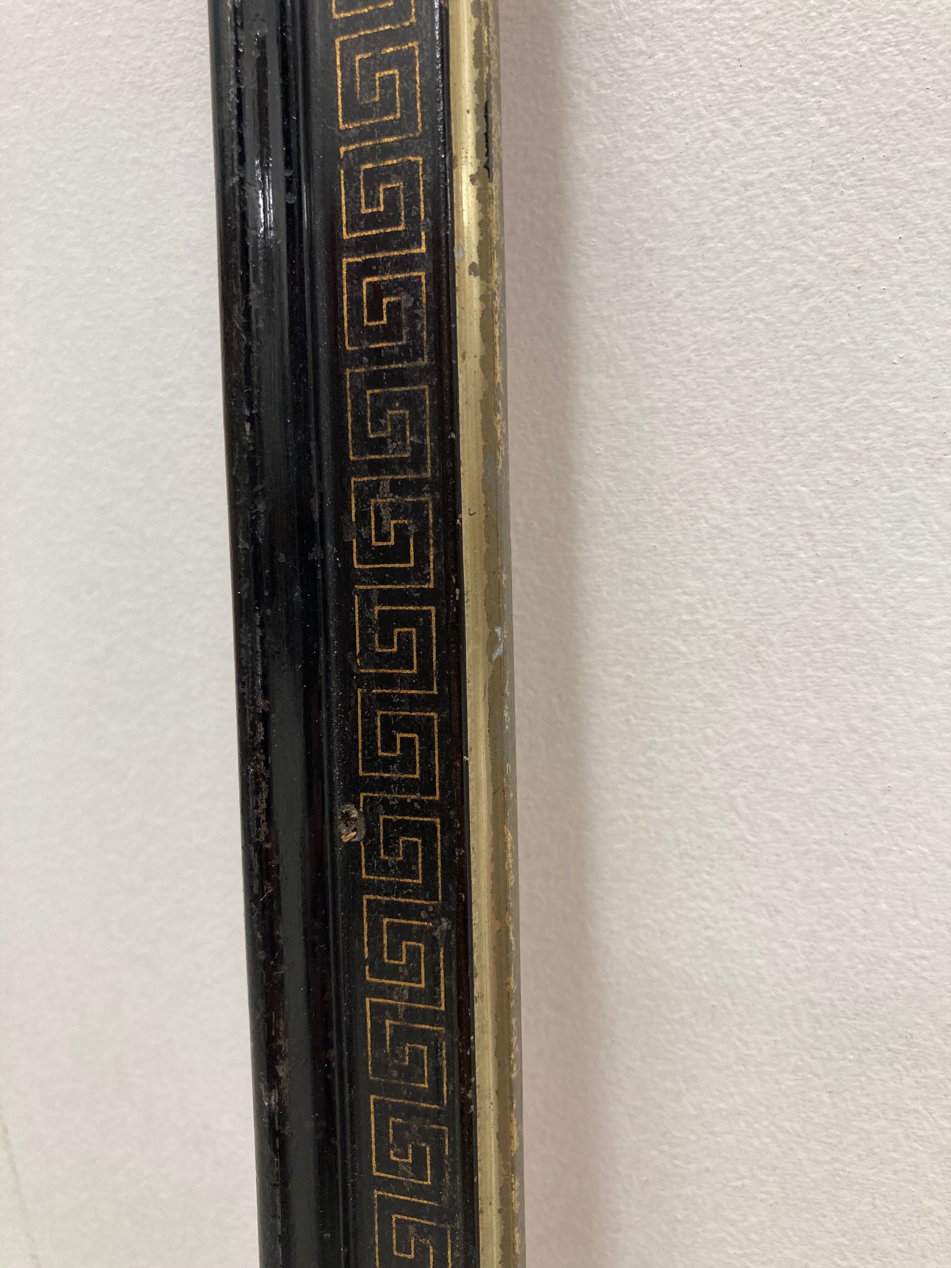 Black and gold frame decorated with Greek frieze decoration