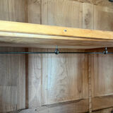 Large antique wardrobe made of solid raw wood and natural caning.