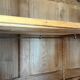 Large antique wardrobe made of solid raw wood and natural caning.