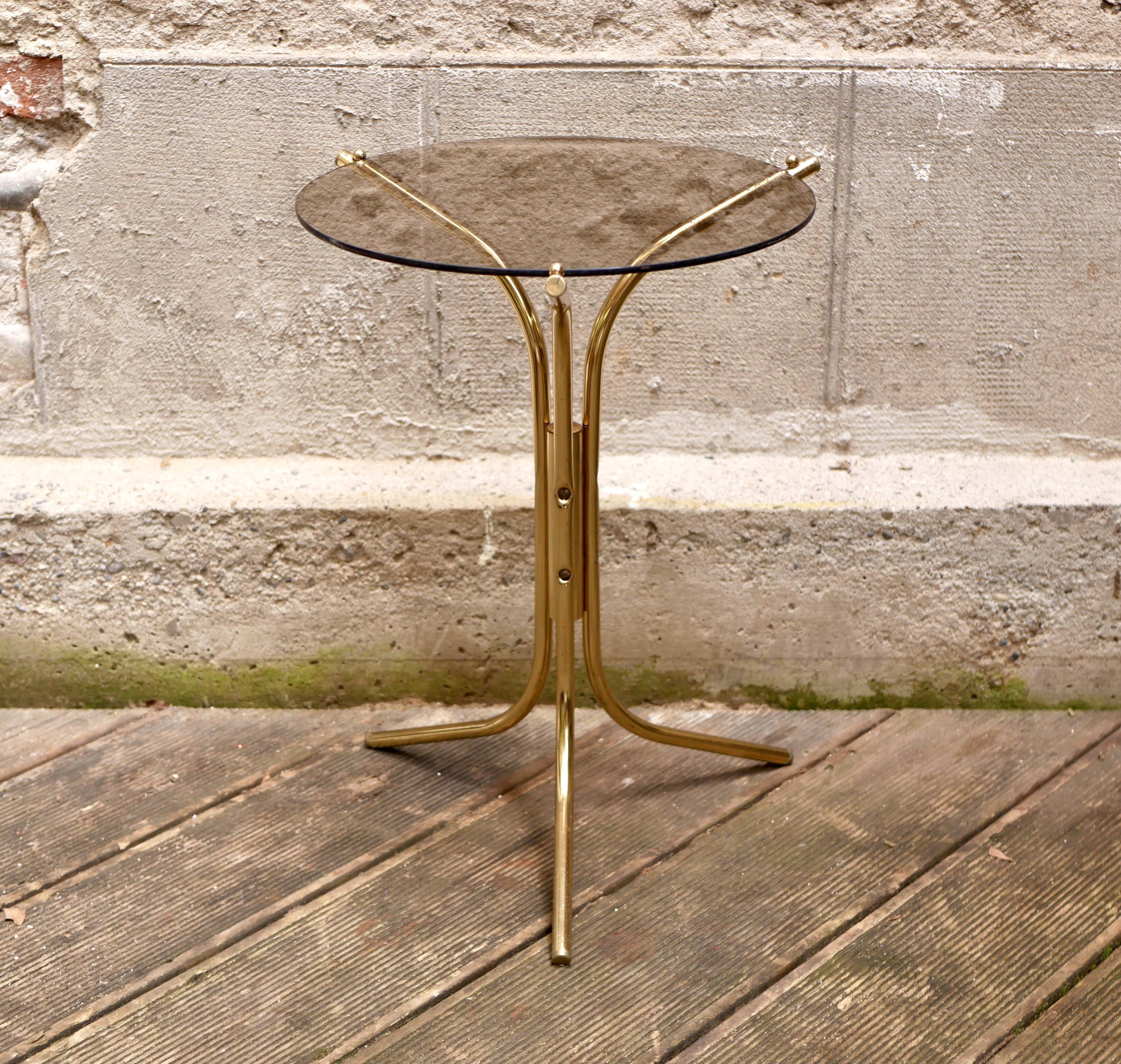 Golden pedestal table in smoked glass