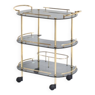 Vintage serving or drinks cart. Gold metal and smoked glass. France, 1960s