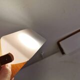 A pair of teak wood wall lamps with plastic shade.