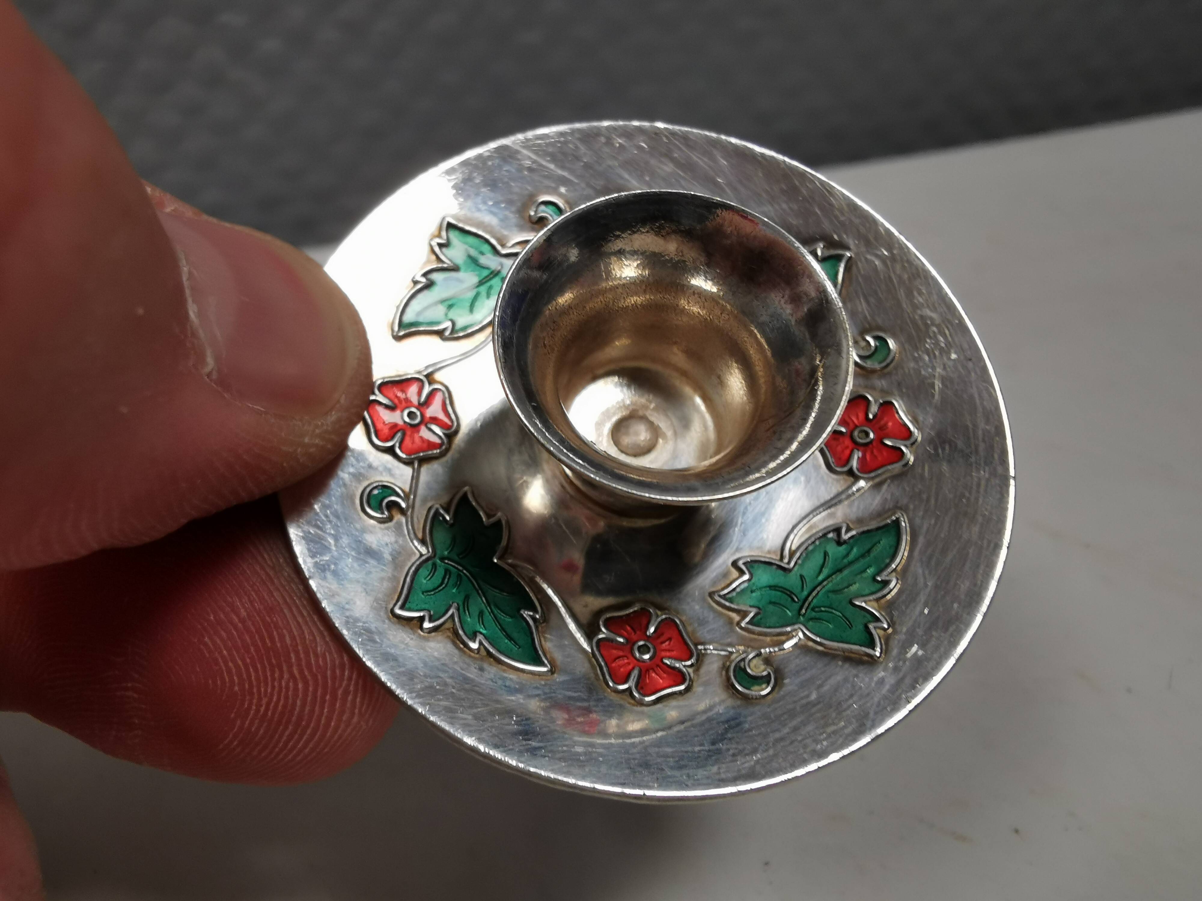 Silver-plated candle holders with inlaid red and green enamel