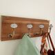 Wall-mounted coat rack with 4 ceramic hooks in blue and white, vintage style.