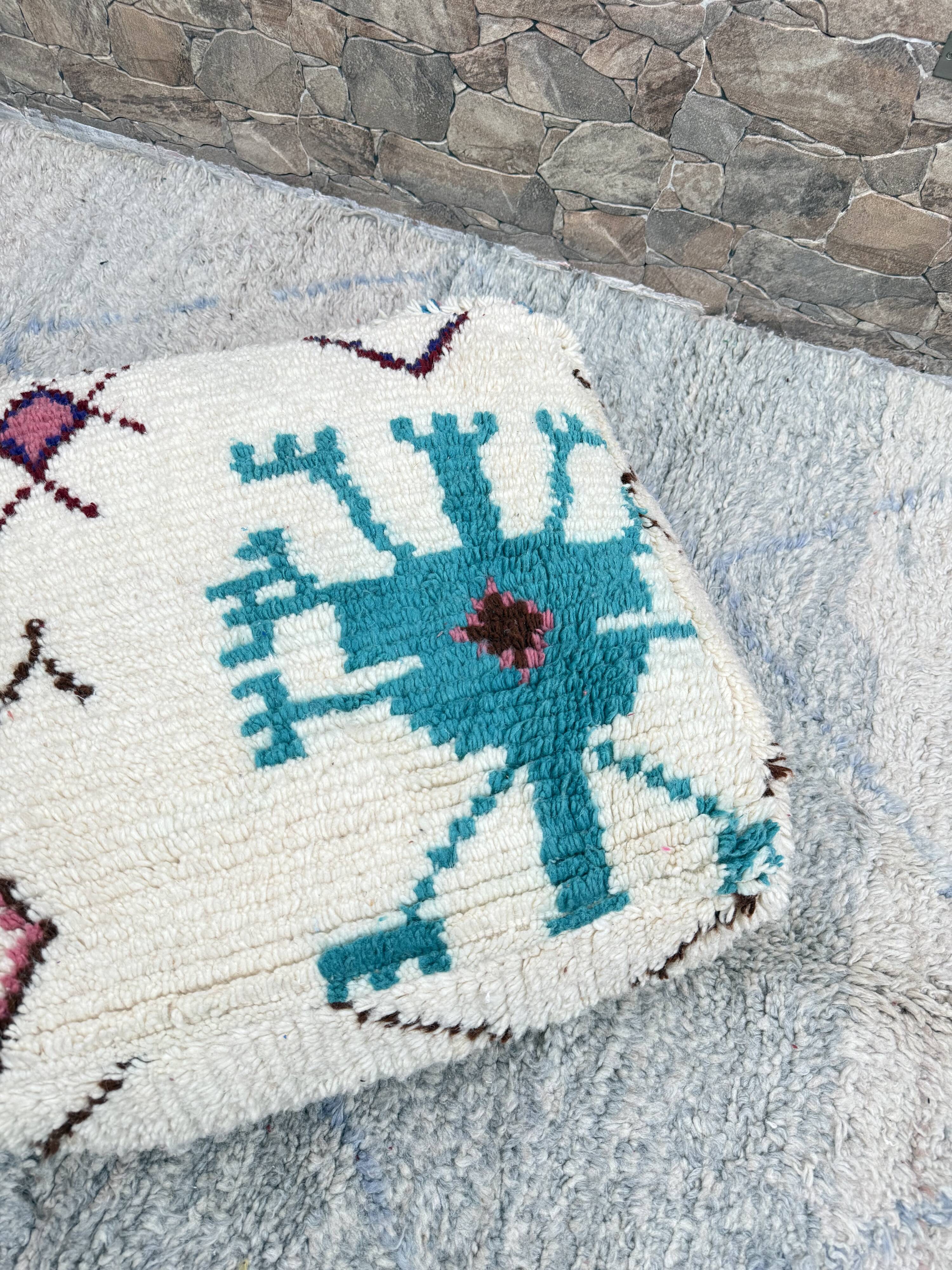 Berber floor pouf: Handwoven Moroccan wool cushion.