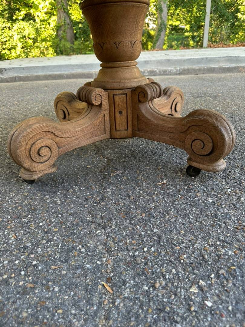 Round dining table with a central pedestal, stripped raw oak, 4 extensions, 19th century.