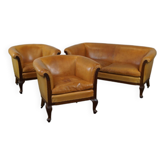 Unique old set of 2 club armchairs and a couch in cognac-colored leather with wheels