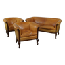Unique old set of 2 club armchairs and a couch in cognac-colored leather with wheels