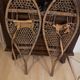 Pair of old snowshoes in wood, leather, and natural gut string