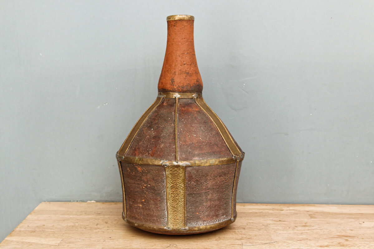Old terracotta and brass bottle