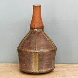 Old terracotta and brass bottle