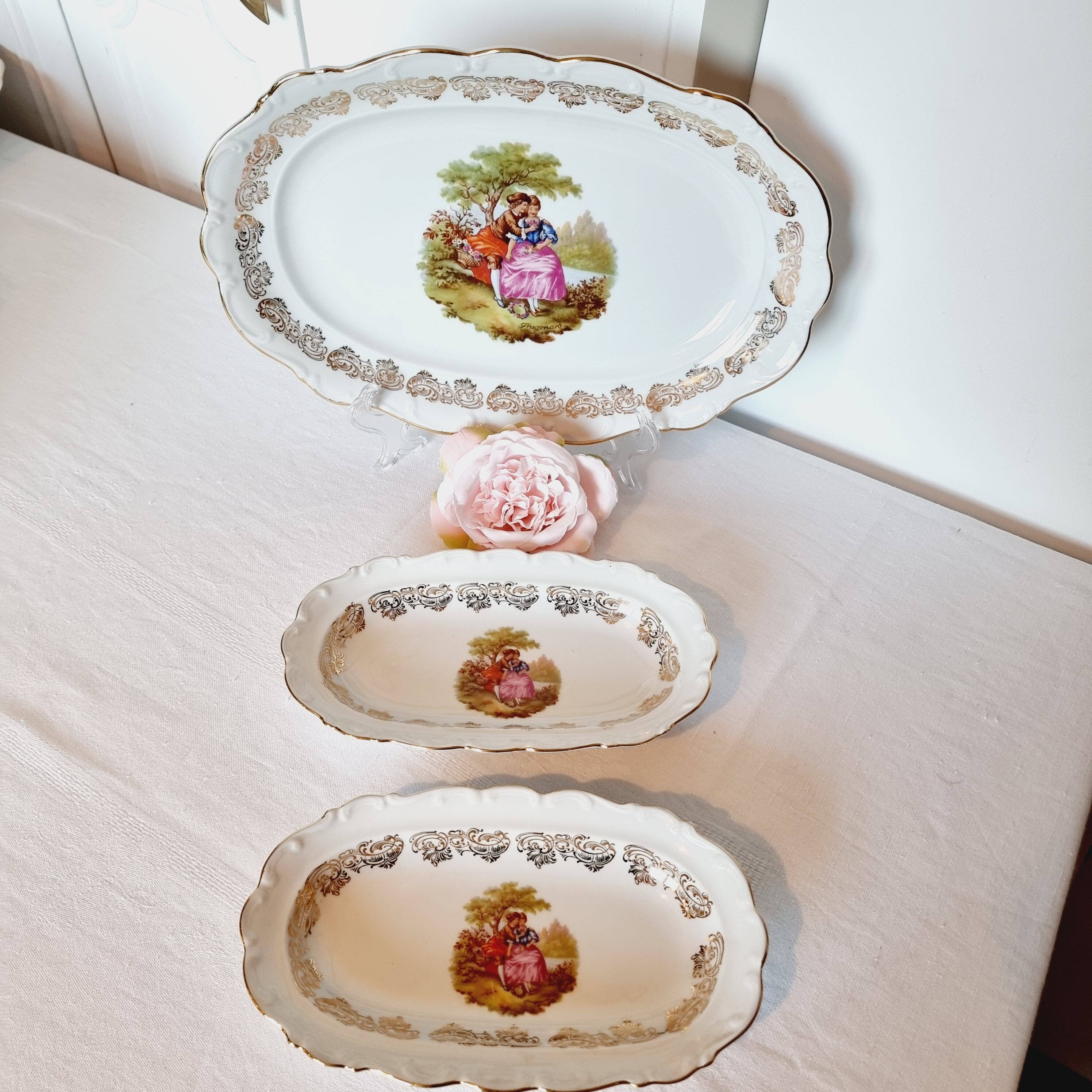 3 serving dishes with frangonard romantic scene with designs and borders in 24 carat gold.