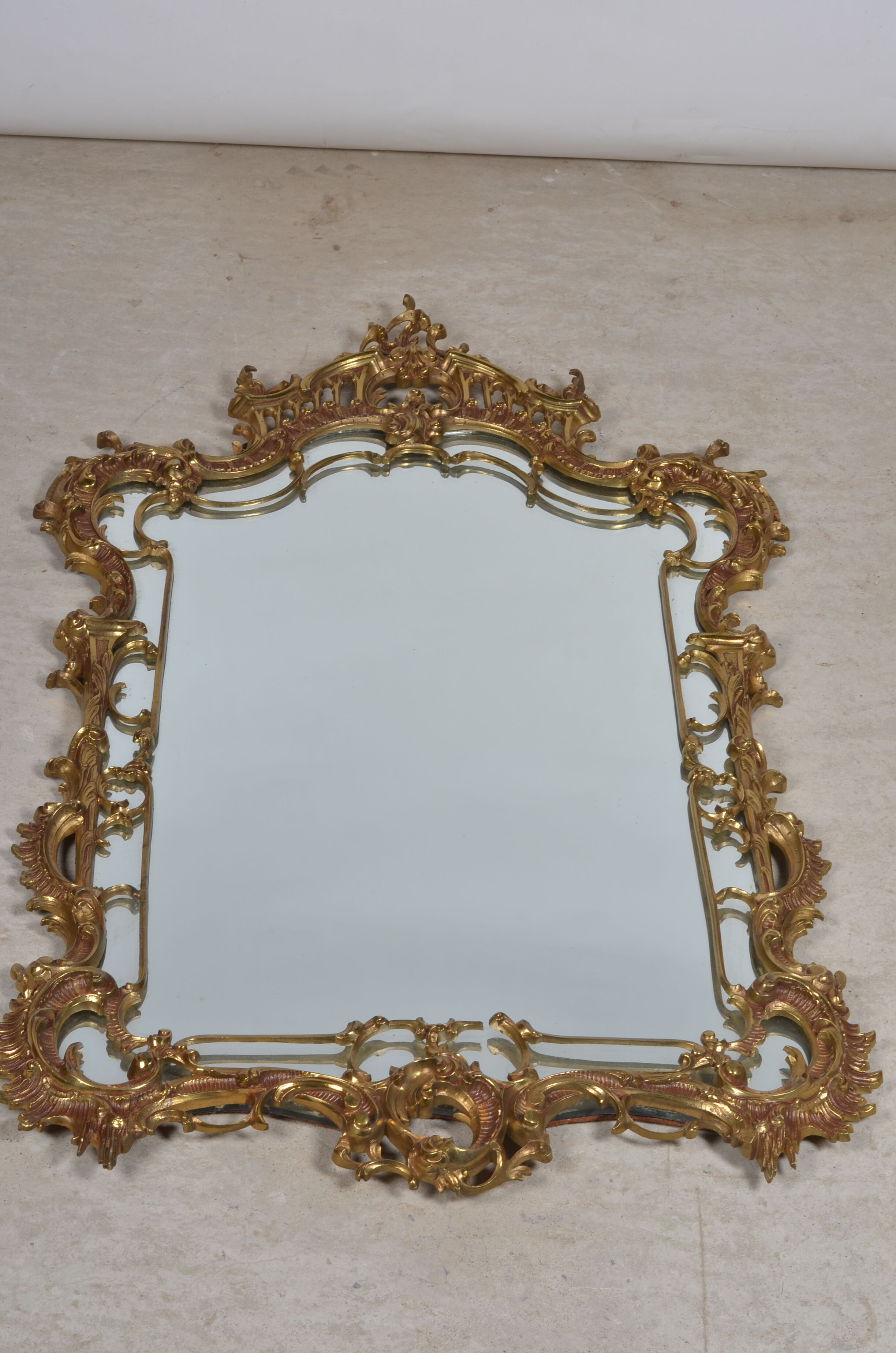 Mirror with baroque style parecloses in bronze 102 x 61 cm