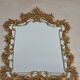 Mirror with baroque style parecloses in bronze 102 x 61 cm