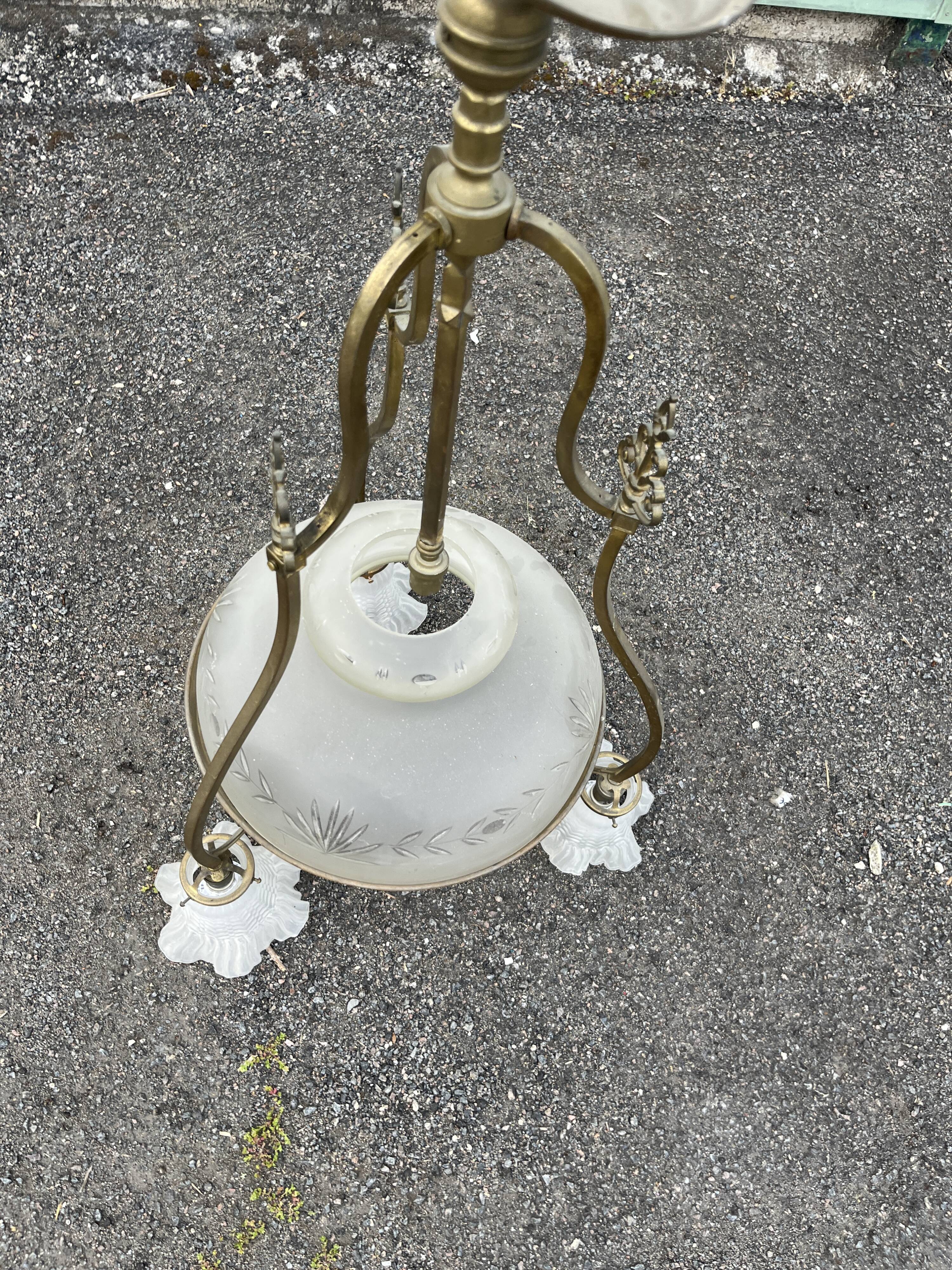 Antique brass chandelier with 3 lights and frosted glass shades.