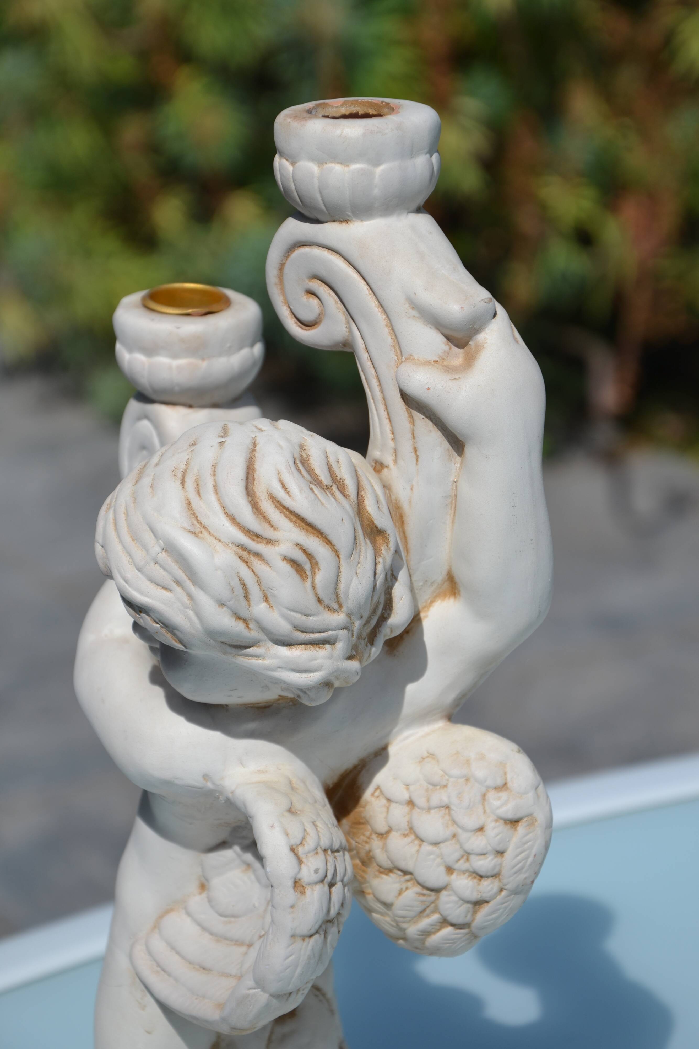 Pair of "cherub" candle holders in plaster