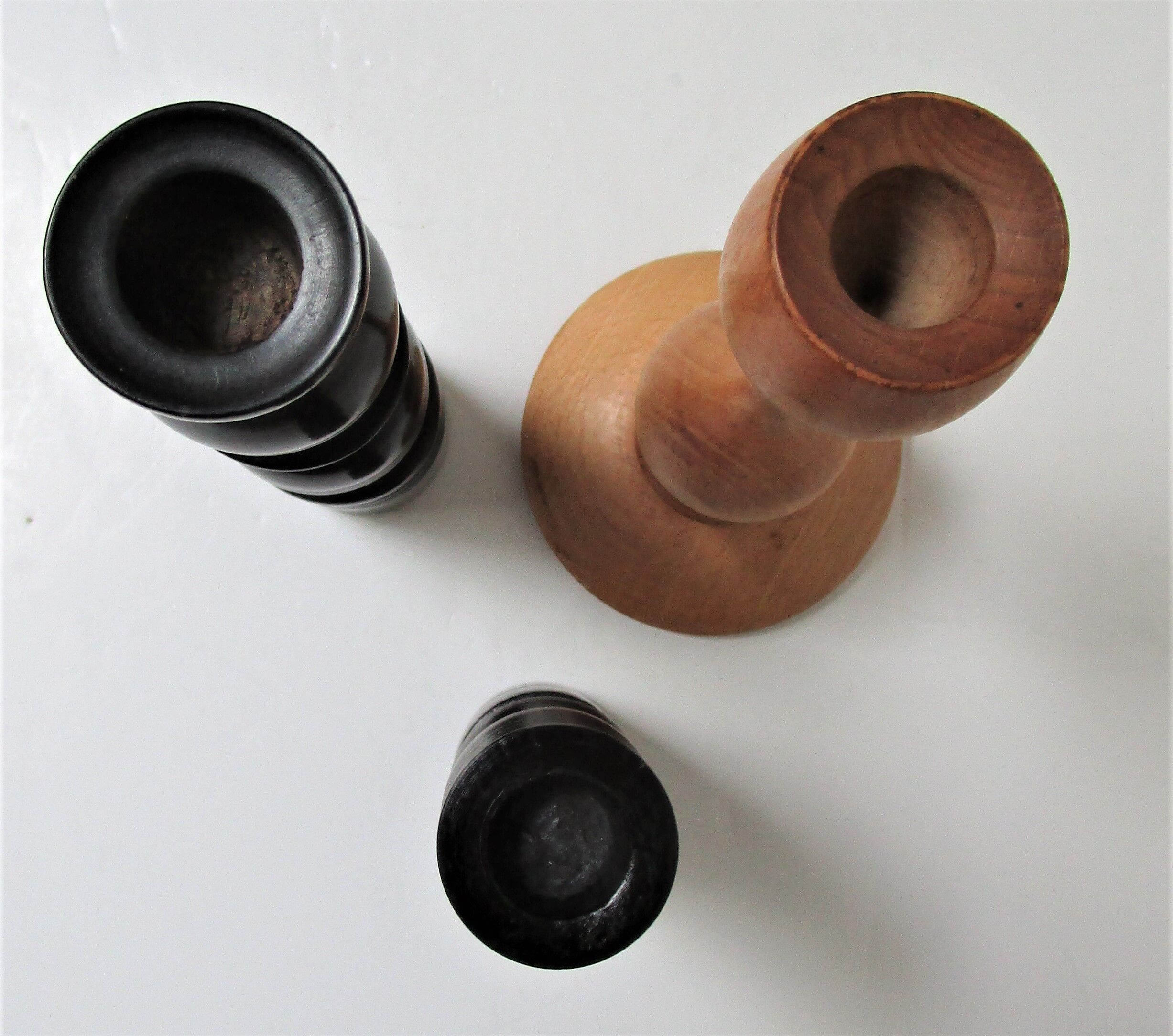 Three vintage light and dark wood candlesticks