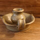 Signed sandstone candle holder