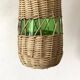 Glass bottles and woven rattan