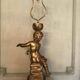 Two carved wooden children, table lamps.