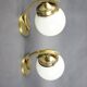 Pair of Art Deco wall sconces in brass and opaline glass, Europe, 1930s