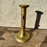 Antique brass candlestick with push button, candlestick.