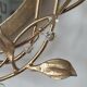 Round mirror in gilded wrought iron and leaves