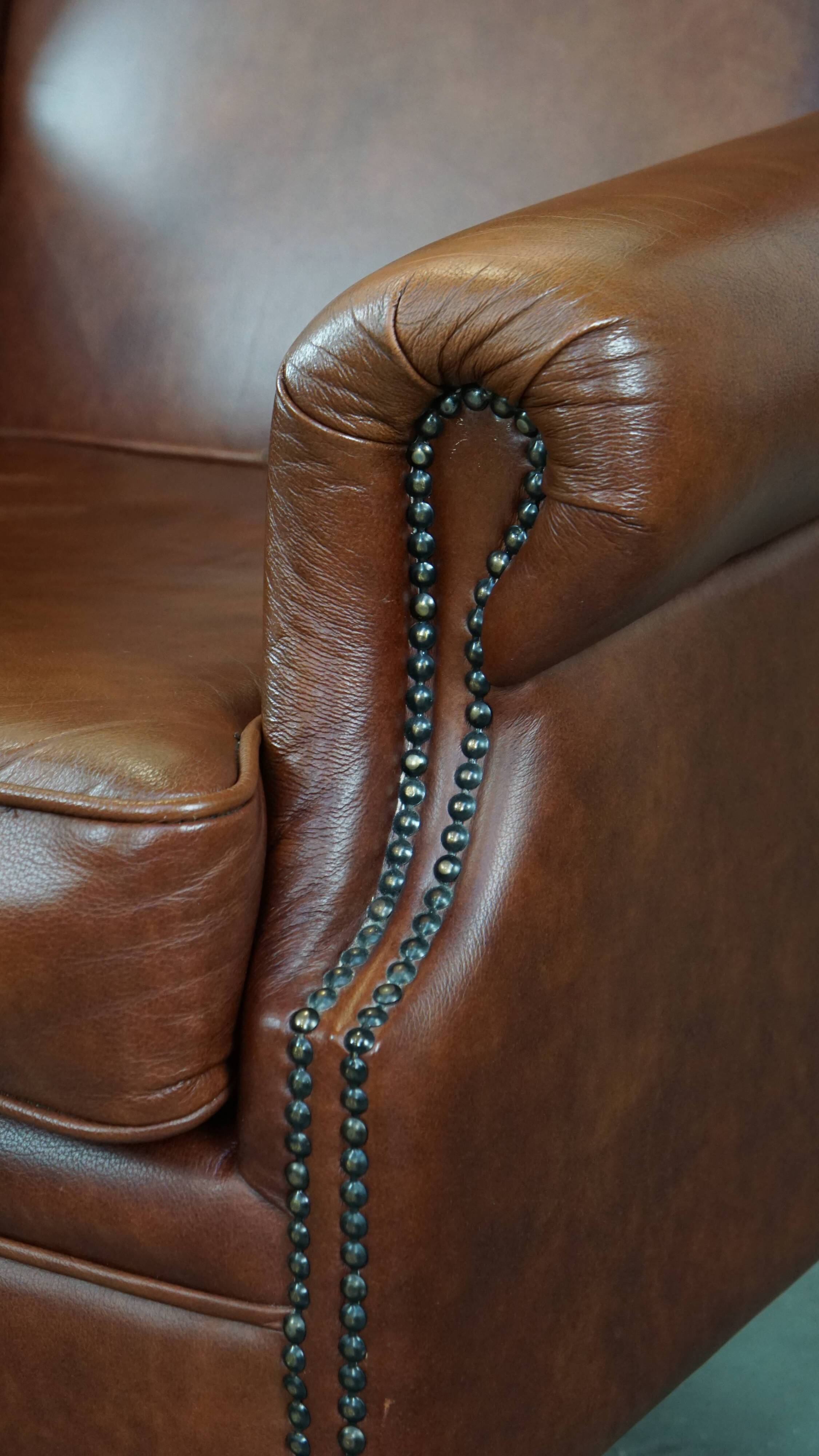 Cognac-colored cowhide wingback chair