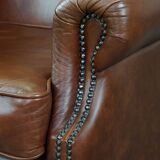 Cognac-colored cowhide wingback chair