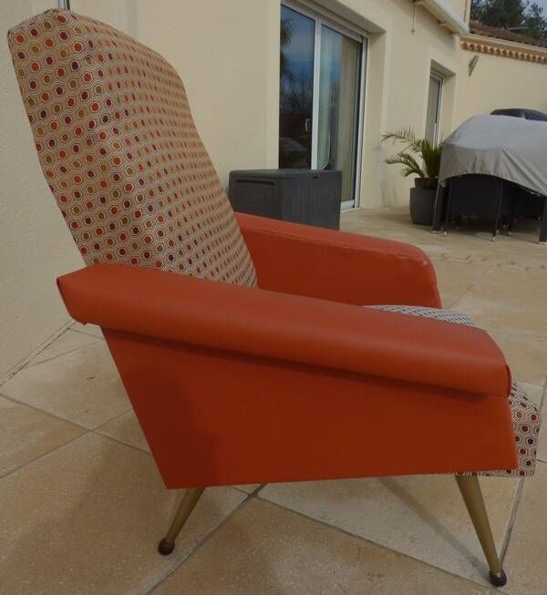 Vintage rockabilly retro armchair in orange faux leather and fabric.