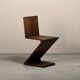 Gerrit Rietveld Zig Zag Chair is dark brown stained wood