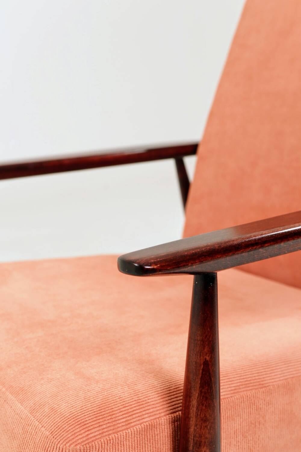 Mid-century modern armchair in coral red designed by H. Lis.