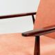 Mid-century modern armchair in coral red designed by H. Lis.