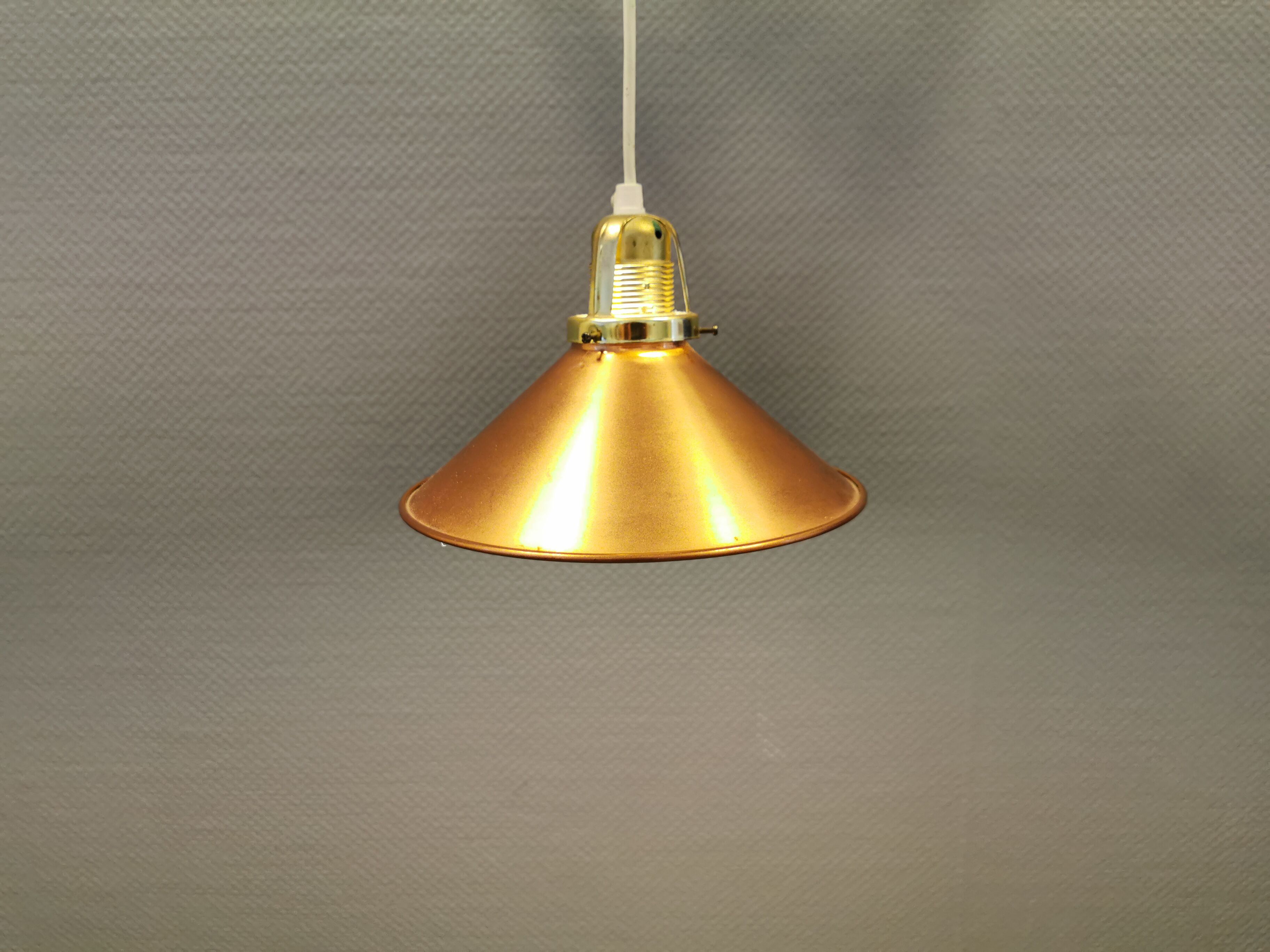 Copper hanging lamp with brass colored top and white inside lacquer.
