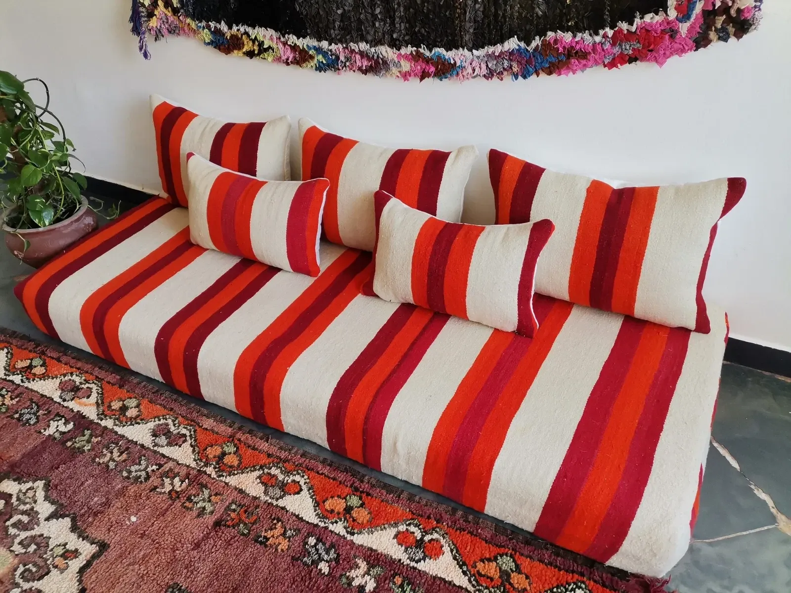 Set of covers for cream and red Moroccan floor sofa.