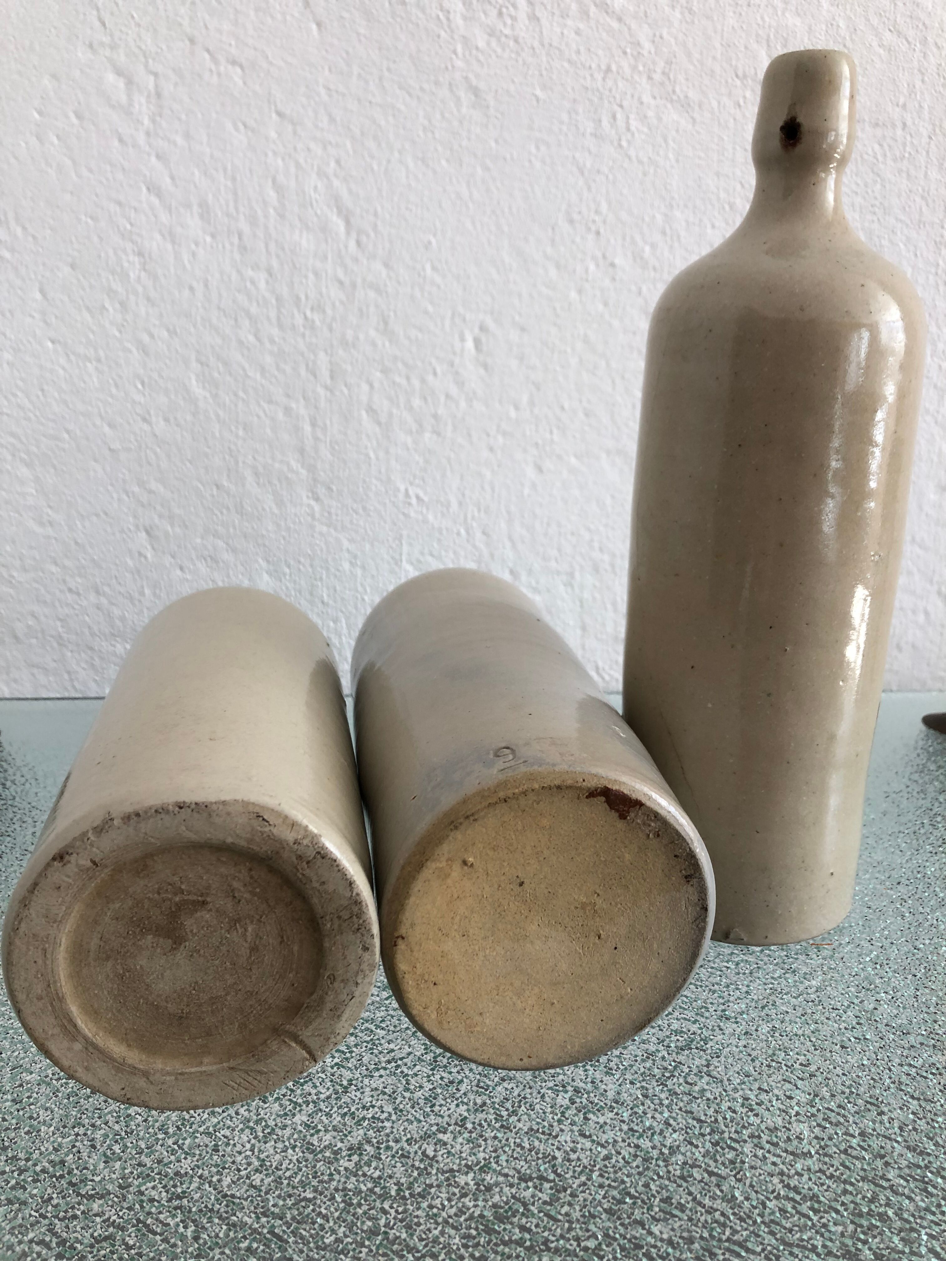 Trio of vintage stoneware bottles