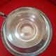 Silver-plated cup and saucer.